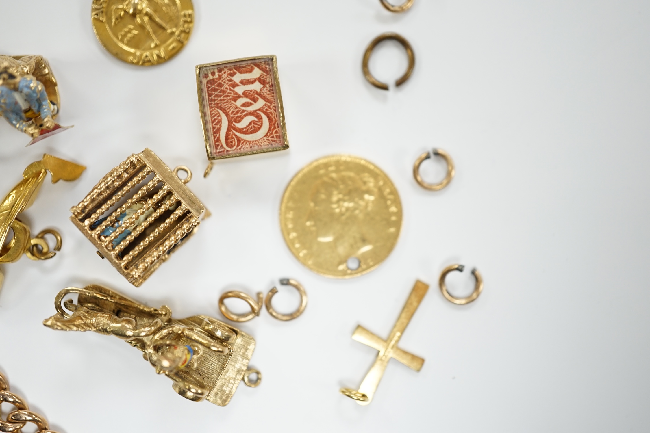 A 9ct gold curb link bracelet and eleven assorted mainly 9ct gold loose charms